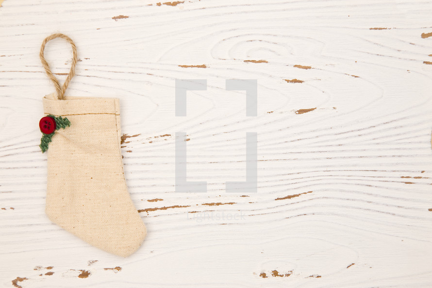 Christmas stocking on white wood background 