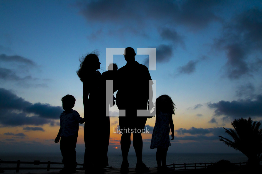 silhouettes of a family at sunset 