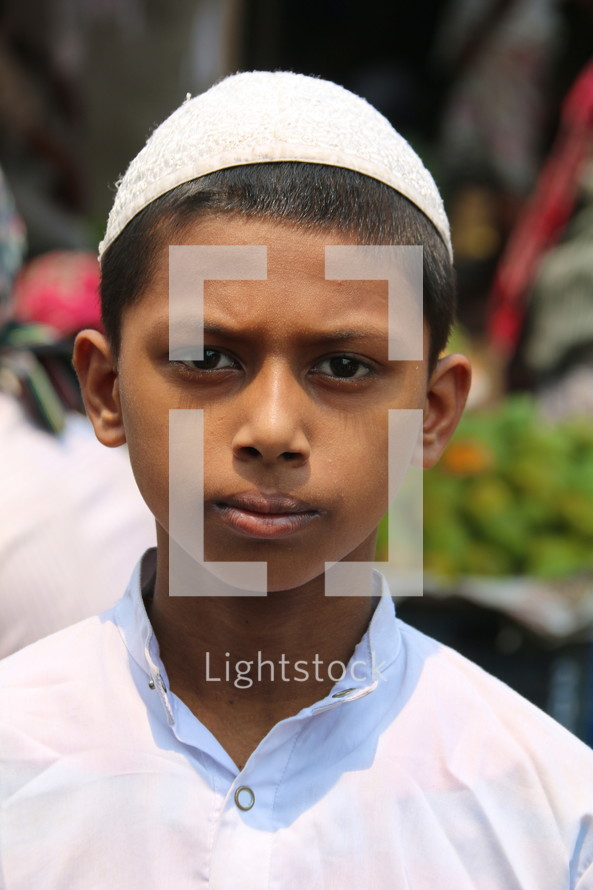 muslim boy child wearing white skull cap