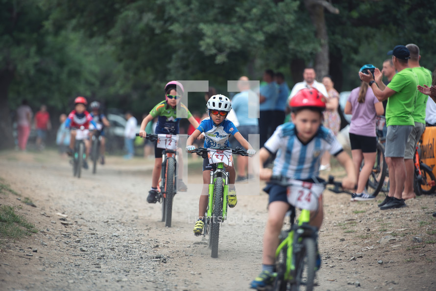 children riding bikes on a dirt bike track during competition 