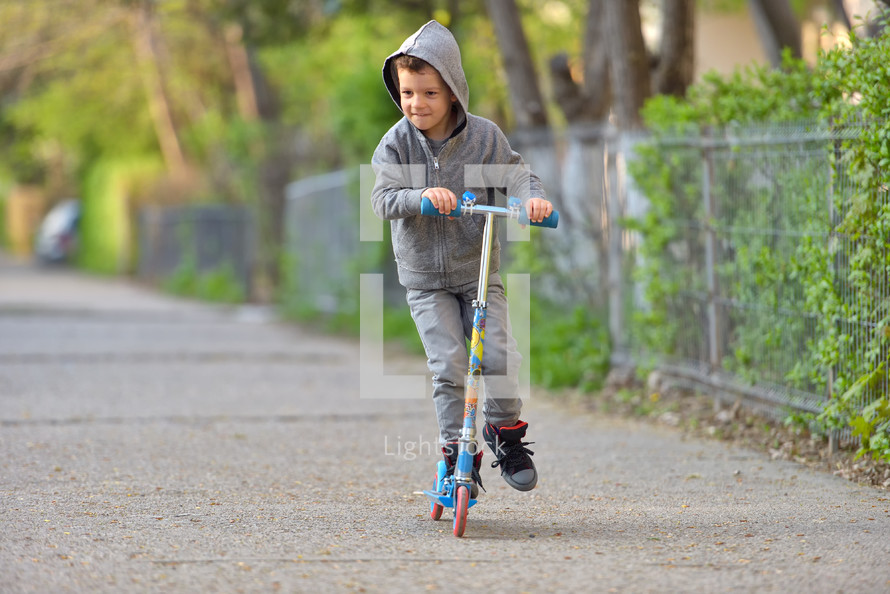 Boy with scooter having fun in the park