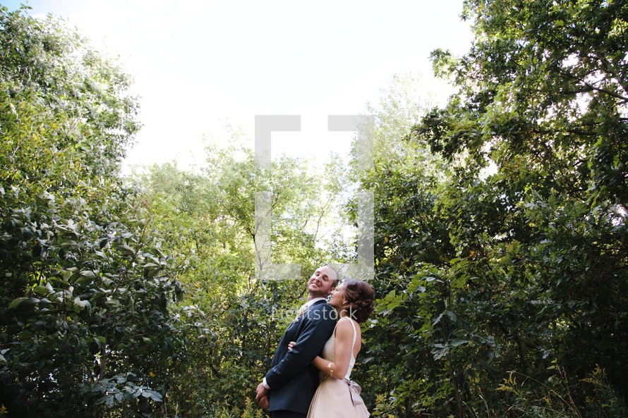 bride and groom standing in a jungle 