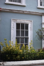 window on a blue row house 