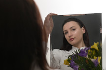 Young Woman and Bouquet Of Freesia Flowers in Mirror