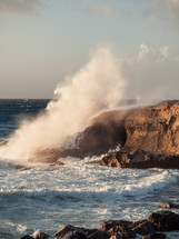 Sea waves crash into the rock
