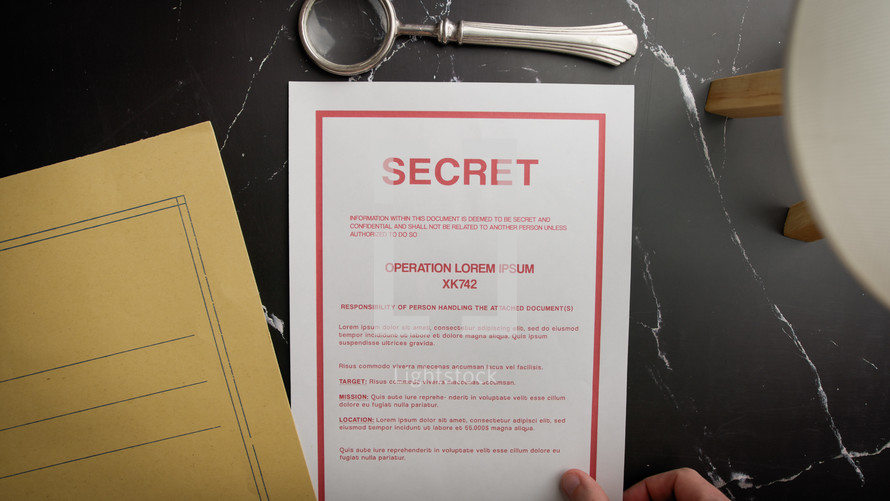 Inspecting a top secret sheet with a magnifying glass