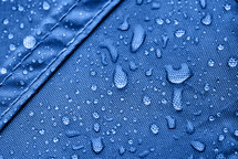 blue rainproof tent sheet with morning rain drops