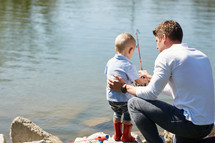 a father fishing with his son.