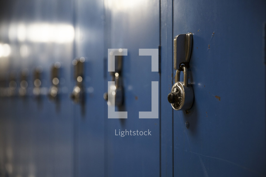 rows of blue lockers in a high school.