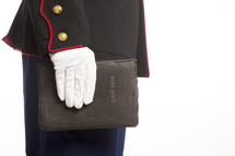 Marine in uniform holding a Holy Bible.