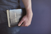 man carrying a Bible at his side 