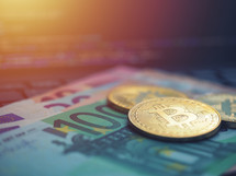 Virtual money golden Bitcoin on Euro background. Bitcoin cryptocurrency exchange concept