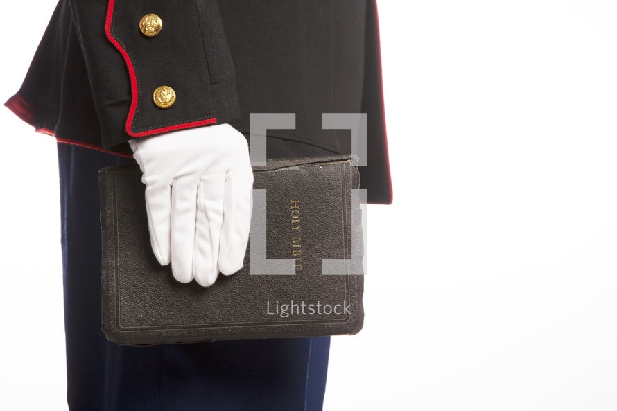 Marine in uniform holding a Holy Bible.