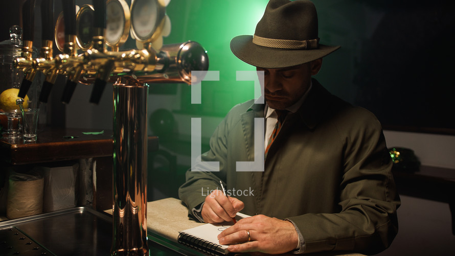 Detective with hat write on notebook