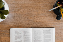 open Bible on a wooden desk 
