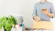 a woman shipping a package - working from home 