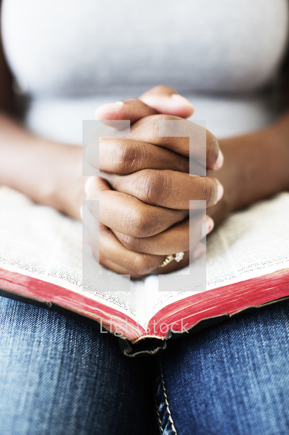 African-American woman reading a Bible in her lap 