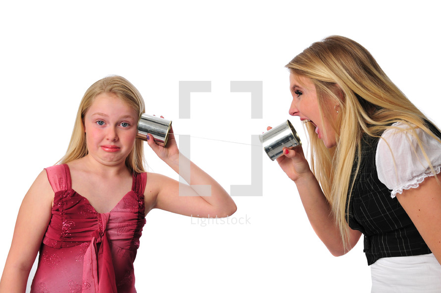 Mother and daughter communicating with tin can phones.