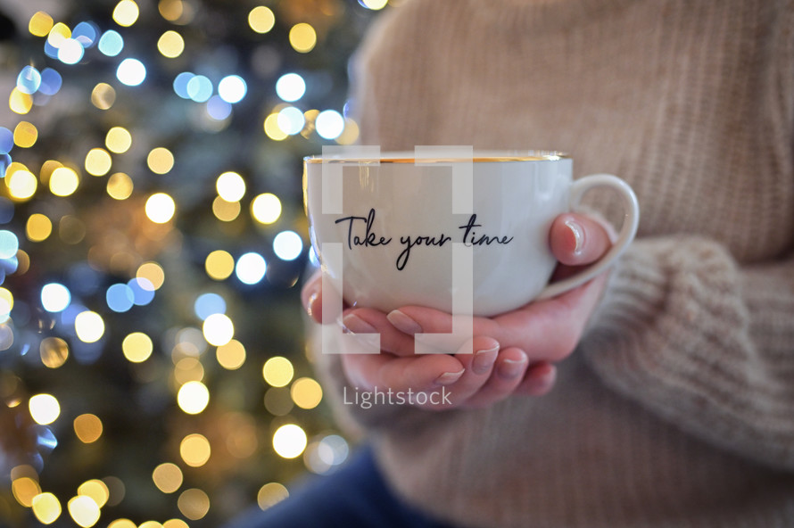 Woman holding a mug that says "take your time"