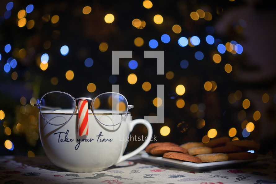 Silly coffee mug with glasses and candy cane with cookie treats