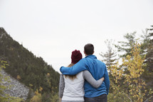 couple hugging on a mountain 