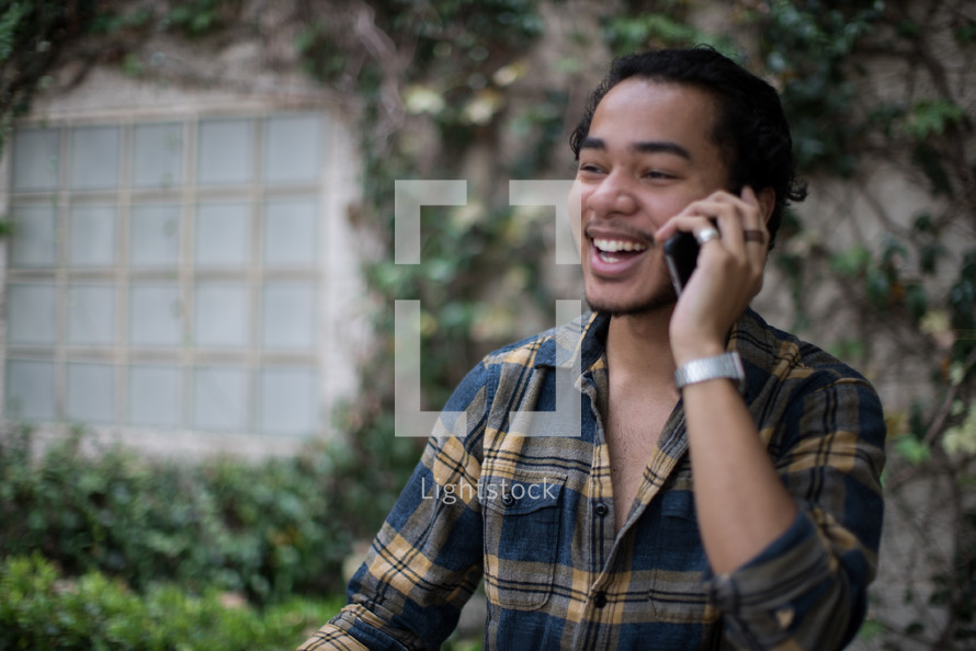 a young man talking on a cellphone 