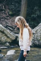 girl exploring a creek 