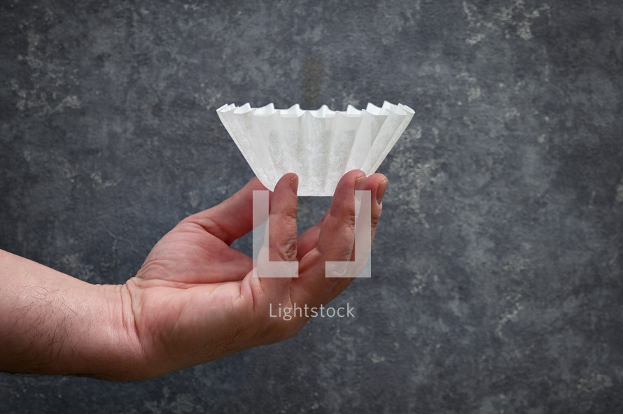 Hand holding a coffee filter