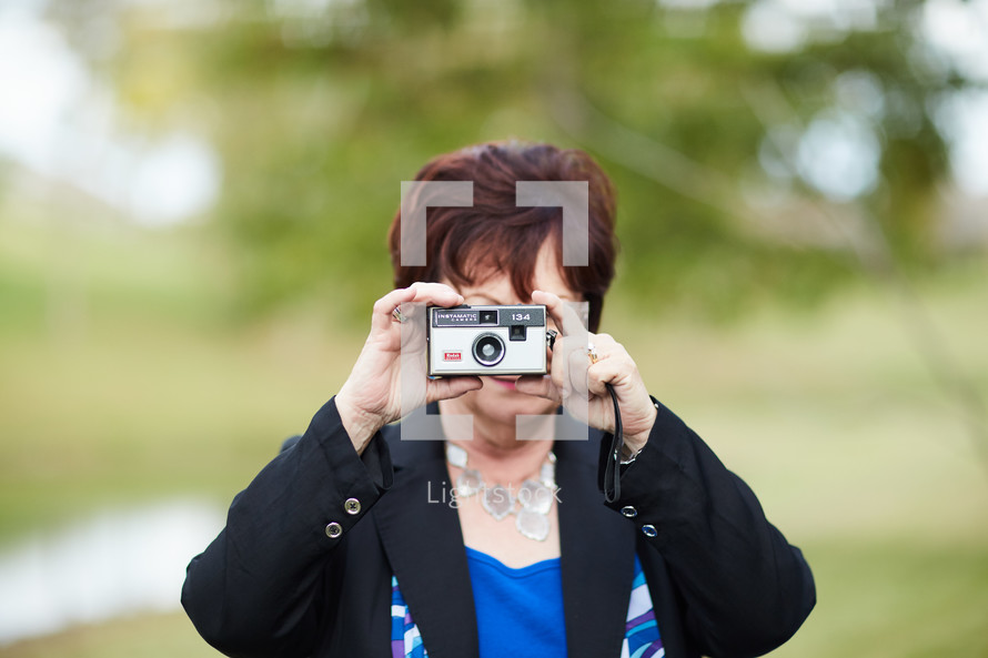 woman taking a picture with a camera 