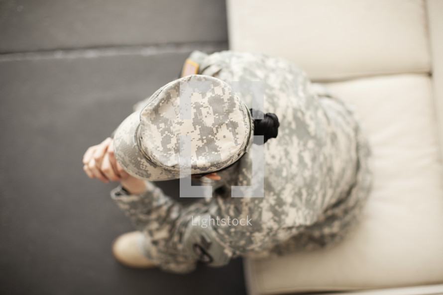 Female soldier in uniform in prayer.