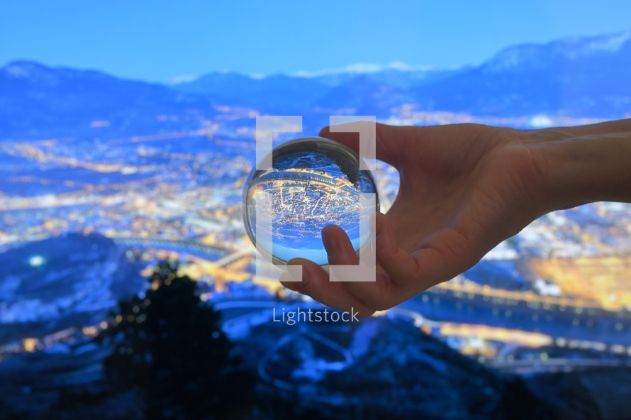 Glass Lens ball and Overview of Trento city in night time
