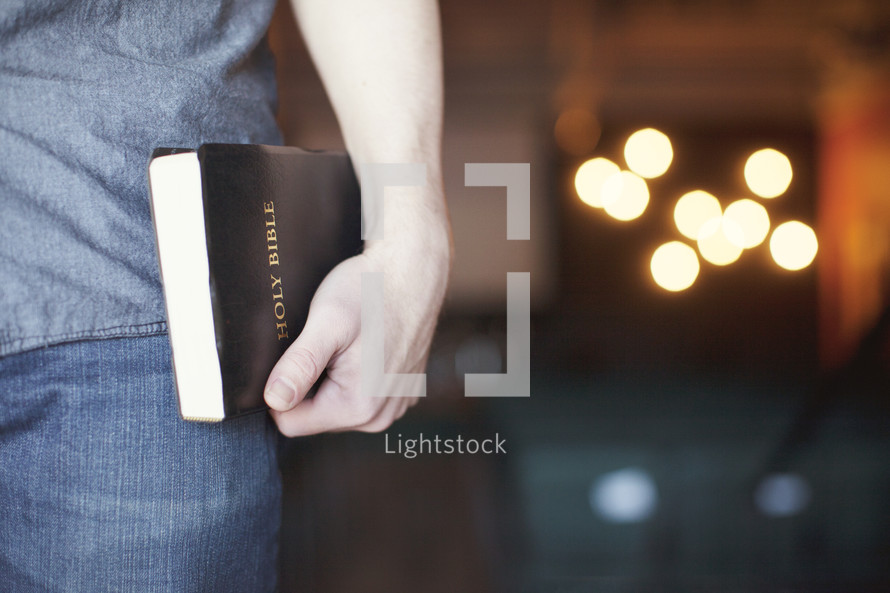 man carrying a Bible to a Bible study 
