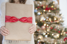 A woman holding a Christmas gift. 