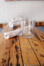 napkins and glasses on a wooden table 