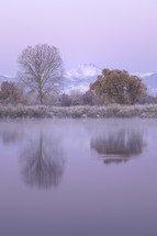 Longs Peak Mountain reflects in the ponds of Longmont Colorado after an early snowfall