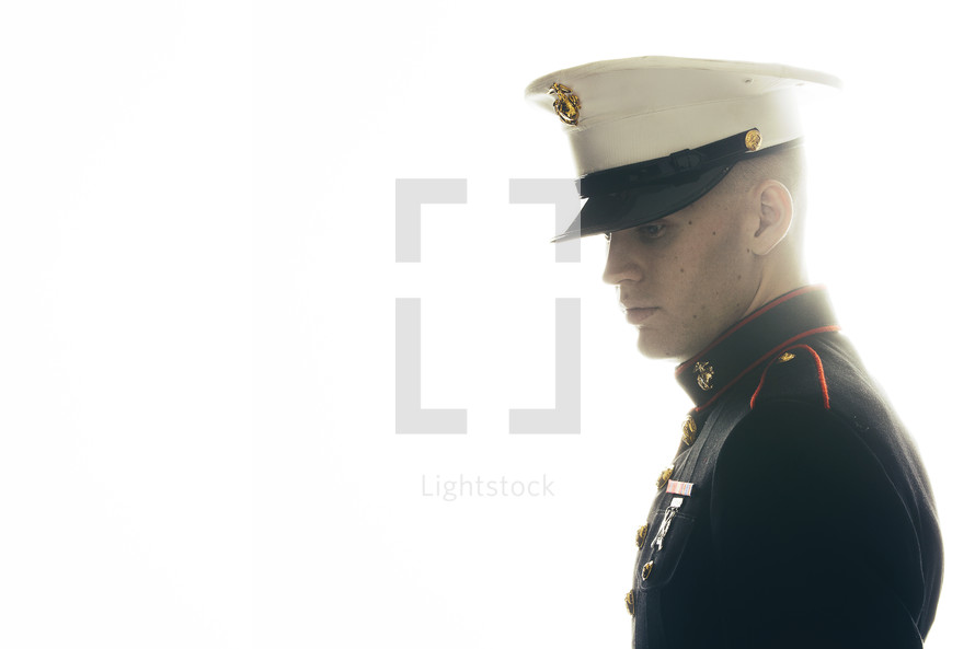 Marine in uniform, looking down to think. 