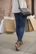 a woman holding shopping bags 