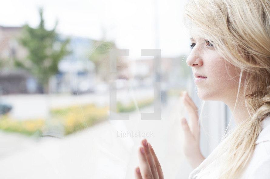 woman looking out a window 
