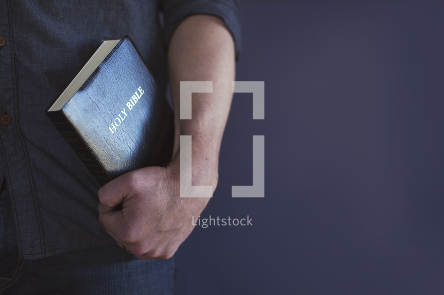 man holding a Bible 