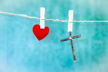 red felt heart and cross made of sticks on a clothesline 