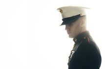 Marine in uniform, looking down to think. 