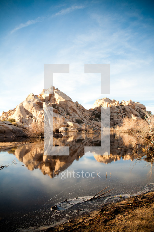 reflection of desert rocks in a pond 