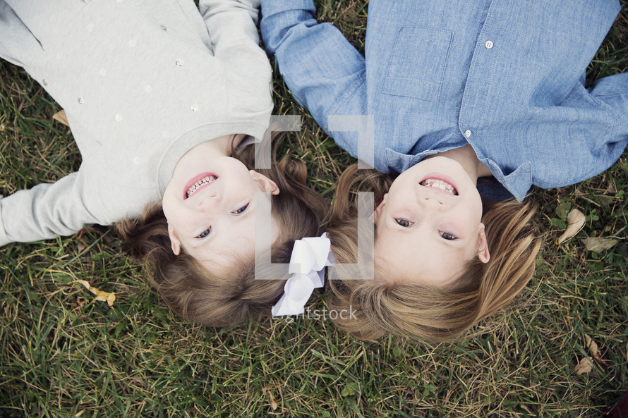 girls lying in the grass 