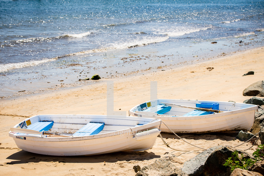 beached rowboats on a beach 