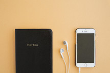 Bible, earbuds, and iPhone 