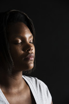 African-American woman with closed eyes in prayer 