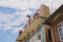 workers repairing a damages building 
