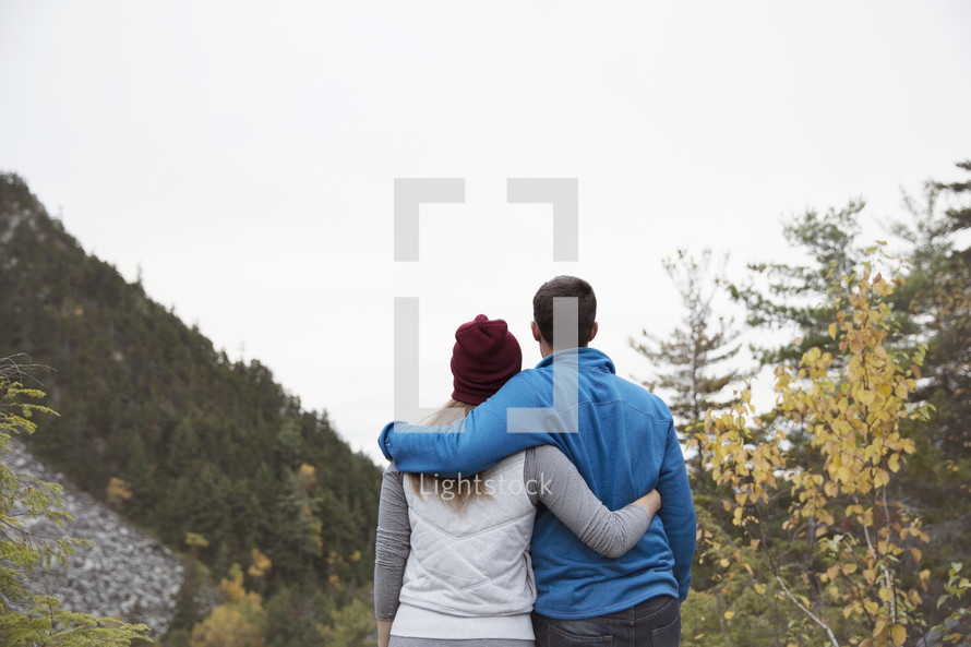 couple hugging on a mountain 