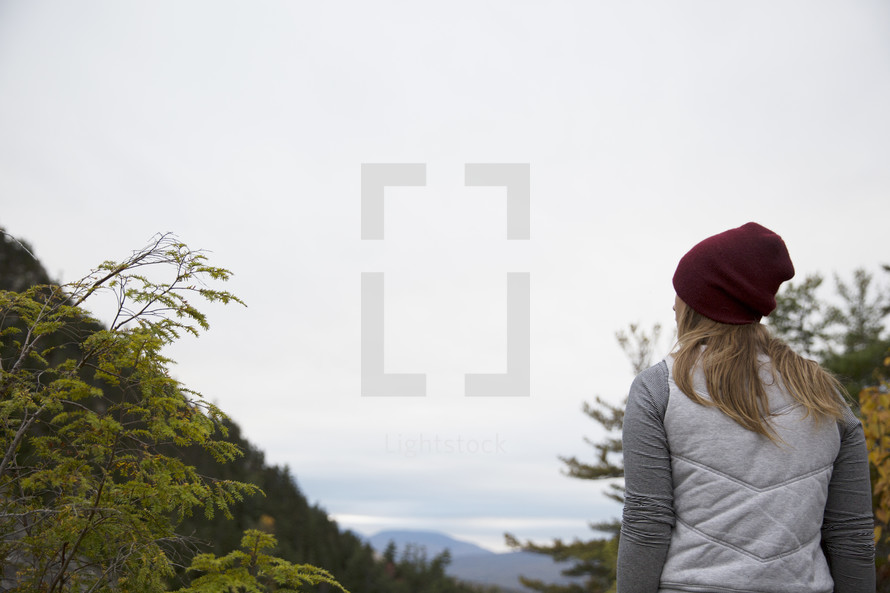 woman looking out at a mountain 