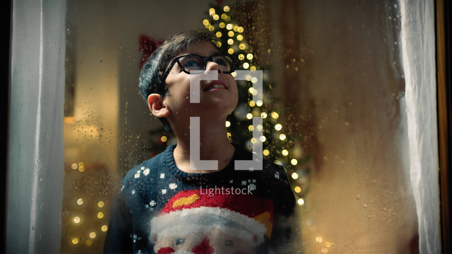 child at the window on Christmas night